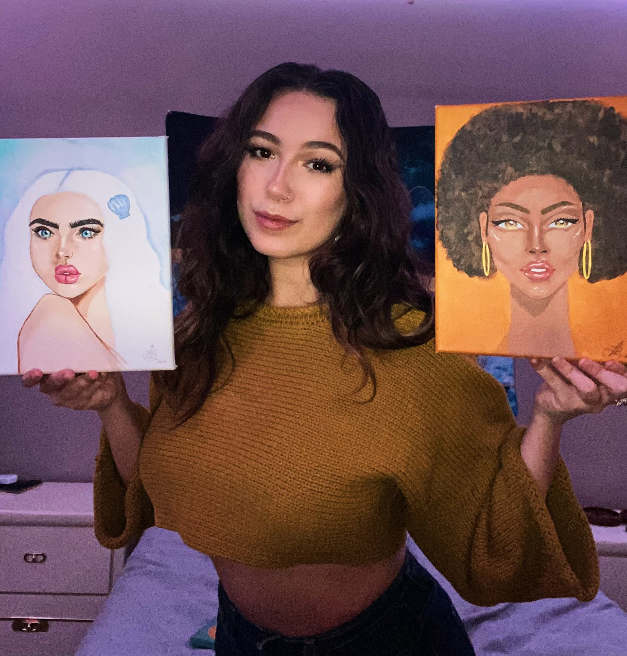 Lotus Burnquist with two paintings from her Zodiac series.